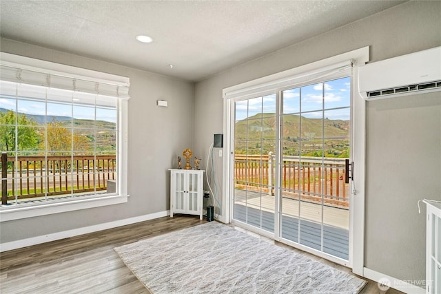 2440 Rock Island Rd, East Wenatchee, WA 98802 - entryway featuring an AC wall unit, wood finished floors, a mountain view, and recessed lighting