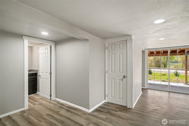 2440 Rock Island Rd, East Wenatchee, WA 98802 - spare room featuring wood finished floors, recessed lighting, and a textured ceiling