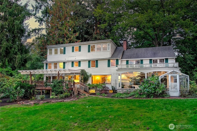 2425 Evergreen Point Rd, Medina, WA 98039 - view of front of home featuring a pergola, a balcony, a chimney, and a lawn