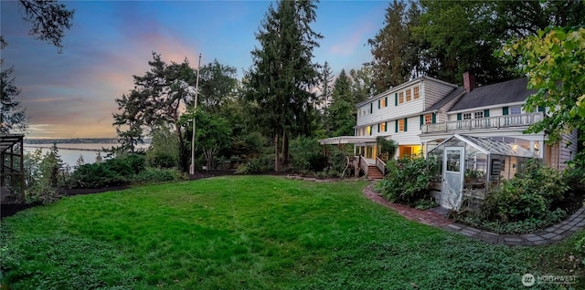 2425 Evergreen Point Rd, Medina, WA 98039 - view of green lawn featuring a deck with water view and a greenhouse