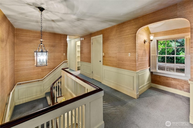 2425 Evergreen Point Rd, Medina, WA 98039 - corridor featuring a chandelier, wainscoting, carpet flooring, and arched walkways