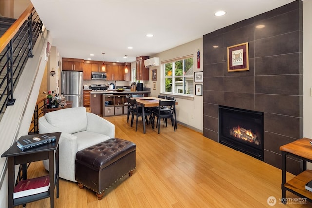 537A Martin Luther King Jr Way S, Seattle, WA 98144 - living room with an AC wall unit, light wood-type flooring, recessed lighting, stairs, and a tiled fireplace