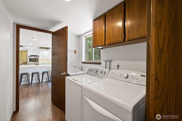 13222 76th Avenue Ct E, Puyallup, WA 98373 - laundry area with cabinet space, washer and clothes dryer, and dark wood finished floors