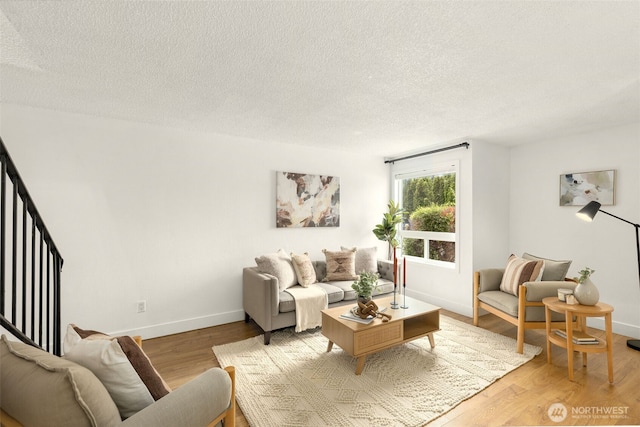 7812 196th St SW Unit B2, Edmonds, WA 98026 - living area featuring a textured ceiling and light wood-style flooring