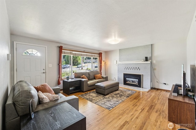 1921 Mountain View Dr, Mount Vernon, WA 98273 - living area with a brick fireplace and light wood-type flooring
