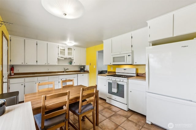 1921 Mountain View Dr, Mount Vernon, WA 98273 - kitchen with white appliances, light tile patterned floors, white cabinetry, and open shelves