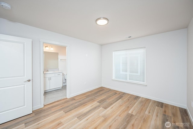 1325 Shaw St, Moses Lake, WA 98837 - unfurnished bedroom with light wood finished floors and connected bathroom