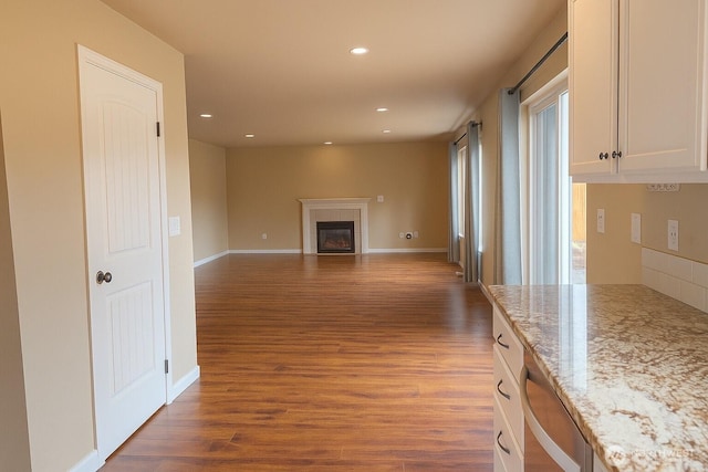 20211 85th Avenue Ct E, Spanaway, WA 98387 - unfurnished living room with dark wood-style flooring, recessed lighting, and a tile fireplace