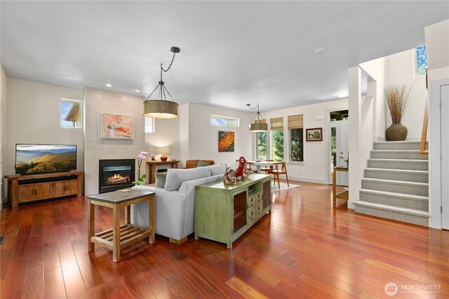 1129 Birch Falls Dr, Bellingham, WA 98229 - living area featuring dark wood-style floors, healthy amount of natural light, a fireplace, and stairway
