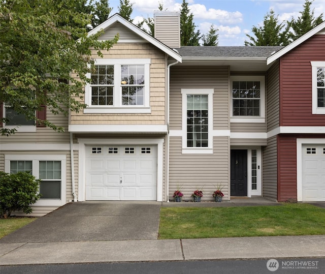 10307 140th Street Ct E Unit 3, Puyallup, WA 98374 - view of front of house with a chimney, concrete driveway, an attached garage, and roof with shingles