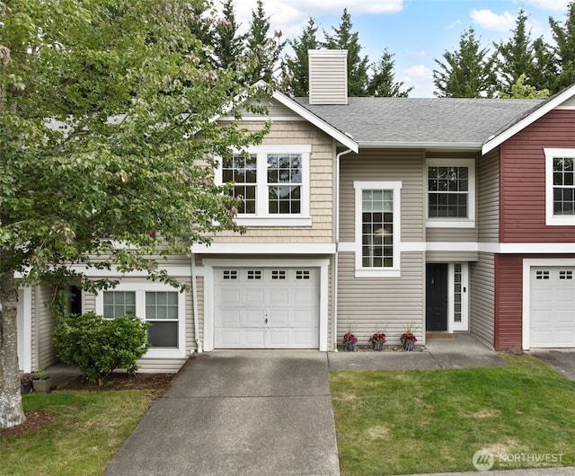 10307 140th Street Ct E Unit 3, Puyallup, WA 98374 - view of front of home with concrete driveway, an attached garage, a chimney, a front yard, and a shingled roof