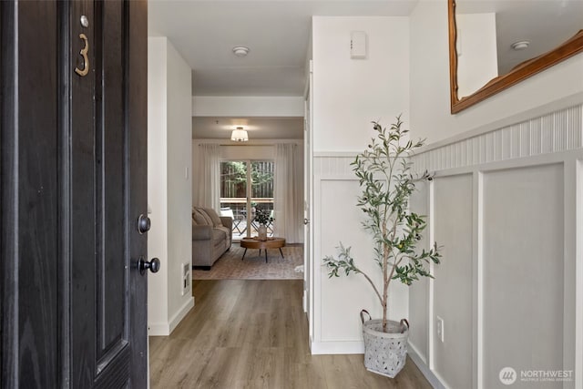 10307 140th Street Ct E Unit 3, Puyallup, WA 98374 - entryway featuring wood finished floors, wainscoting, and a decorative wall