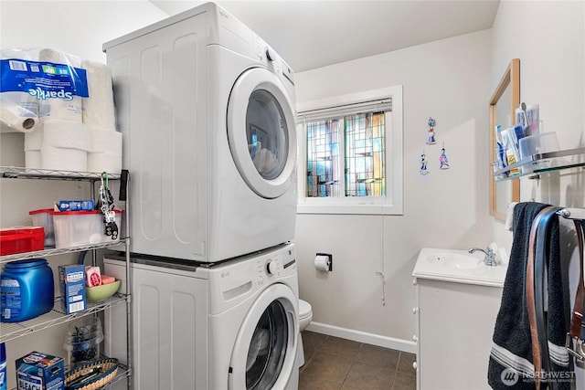 32867 42nd Pl SW, Federal Way, WA 98023 - laundry room featuring stacked washing machine and dryer and dark tile patterned flooring