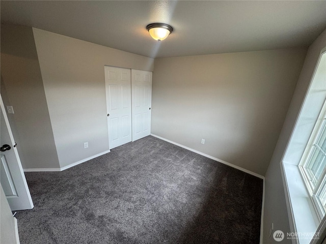 20116 85th Avenue Ct E, Spanaway, WA 98387 - unfurnished bedroom with dark carpet and a closet