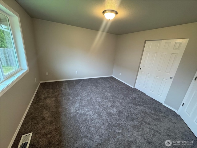 20116 85th Avenue Ct E, Spanaway, WA 98387 - unfurnished bedroom with dark colored carpet and a closet