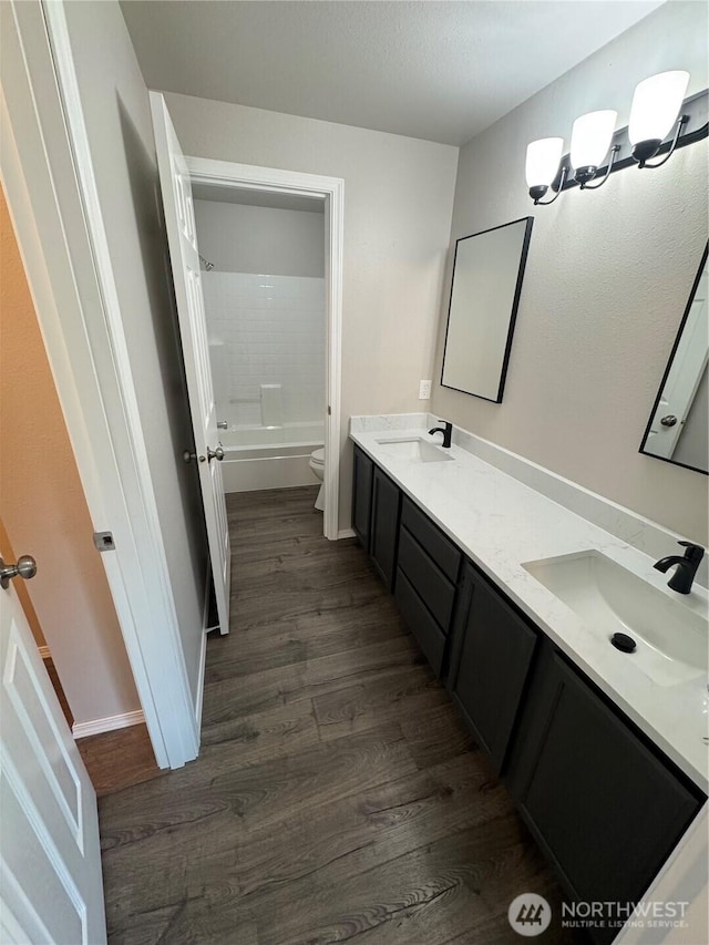 20116 85th Avenue Ct E, Spanaway, WA 98387 - full bath featuring double vanity, wood finished floors, and shower / washtub combination