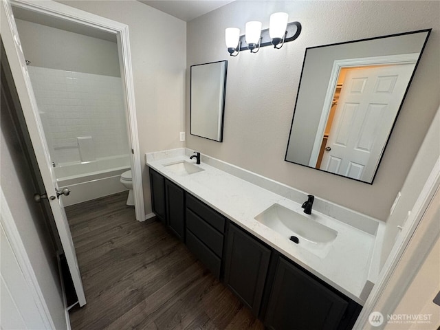 20116 85th Avenue Ct E, Spanaway, WA 98387 - full bath with wood finished floors, double vanity, and shower / washtub combination