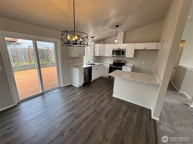 20116 85th Avenue Ct E, Spanaway, WA 98387 - kitchen featuring appliances with stainless steel finishes, white cabinetry, light countertops, dark wood finished floors, and vaulted ceiling