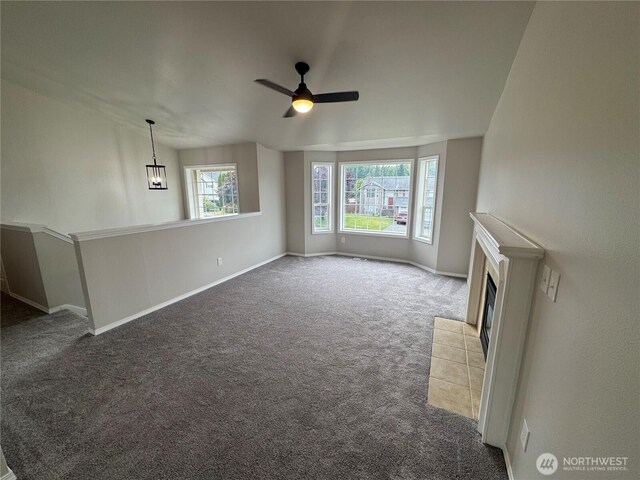 20116 85th Avenue Ct E, Spanaway, WA 98387 - unfurnished living room with carpet flooring, a fireplace, and a ceiling fan