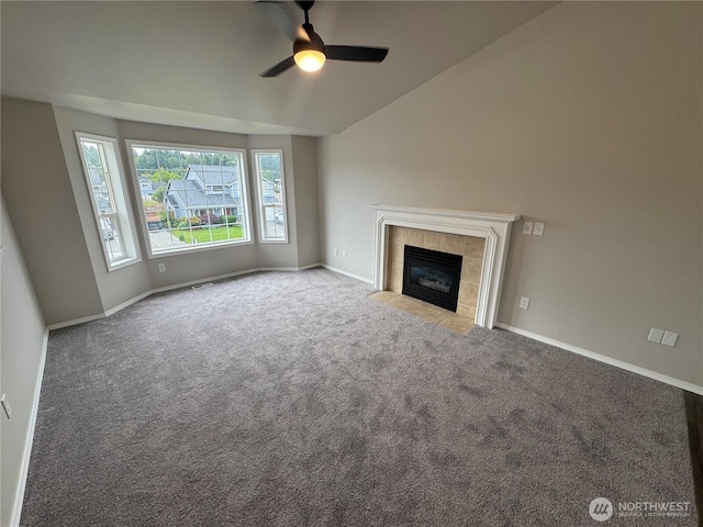 20116 85th Avenue Ct E, Spanaway, WA 98387 - unfurnished living room featuring a ceiling fan, carpet floors, a tile fireplace, and vaulted ceiling