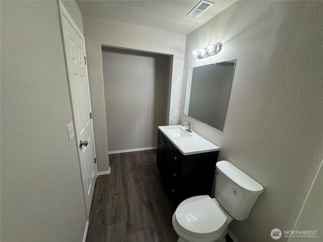 20116 85th Avenue Ct E, Spanaway, WA 98387 - half bathroom with vanity, wood finished floors, and a textured wall