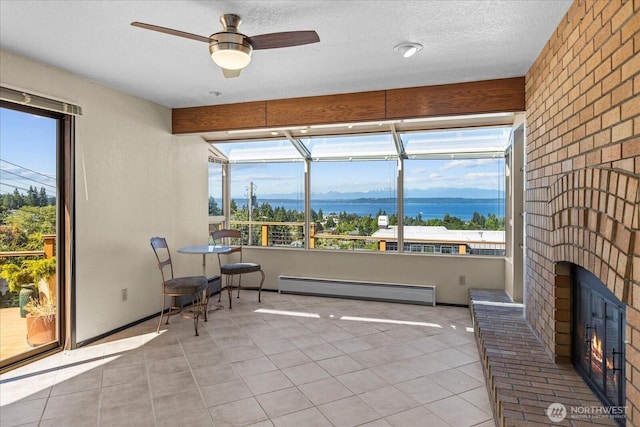 1125 Vista Pl, Edmonds, WA 98020 - sunroom / solarium with baseboard heating, a ceiling fan, healthy amount of natural light, and a brick fireplace