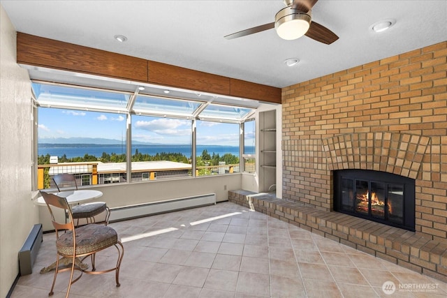 1125 Vista Pl, Edmonds, WA 98020 - sunroom / solarium featuring a brick fireplace, a baseboard heating unit, a baseboard radiator, and a ceiling fan