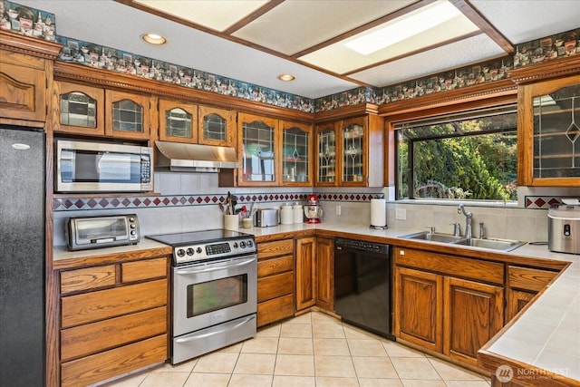 1125 Vista Pl, Edmonds, WA 98020 - kitchen featuring appliances with stainless steel finishes, under cabinet range hood, backsplash, brown cabinetry, and recessed lighting