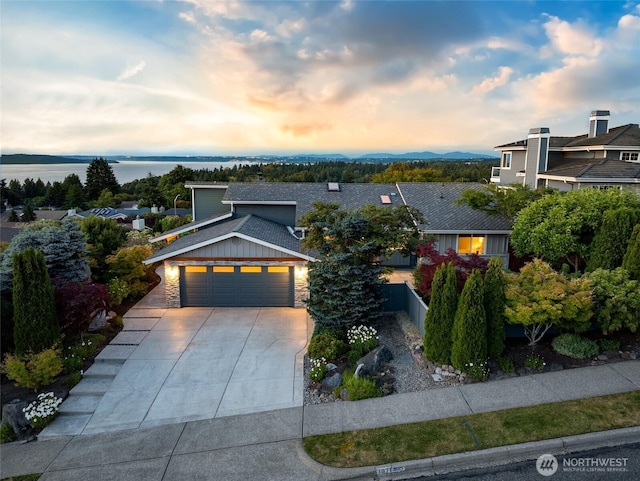 1871 Hillside Dr NE, Tacoma, WA 98422 - modern home featuring driveway, an attached garage, stone siding, and roof with shingles