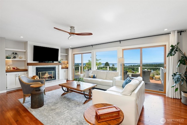 1871 Hillside Dr NE, Tacoma, WA 98422 - living area featuring a glass covered fireplace, ceiling fan, hardwood / wood-style floors, and recessed lighting