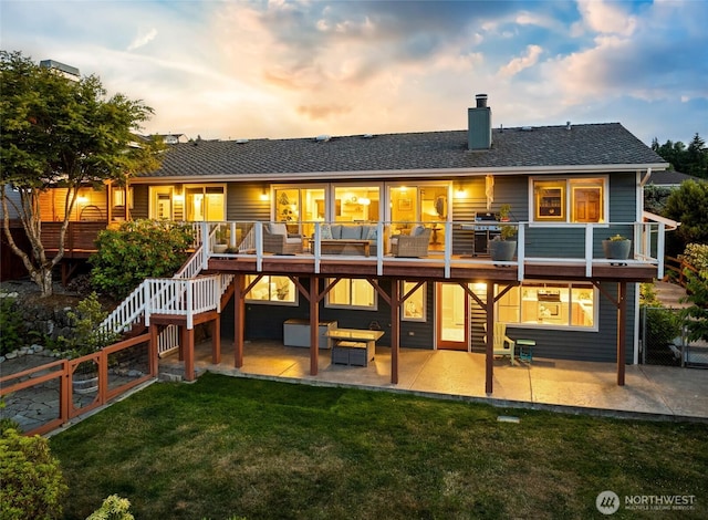 1871 Hillside Dr NE, Tacoma, WA 98422 - back of house at dusk featuring a patio, stairway, a chimney, an outdoor living space, and a shingled roof