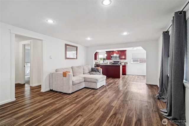 6817 S D St, Tacoma, WA 98408 - living area featuring arched walkways, dark wood-style floors, and recessed lighting
