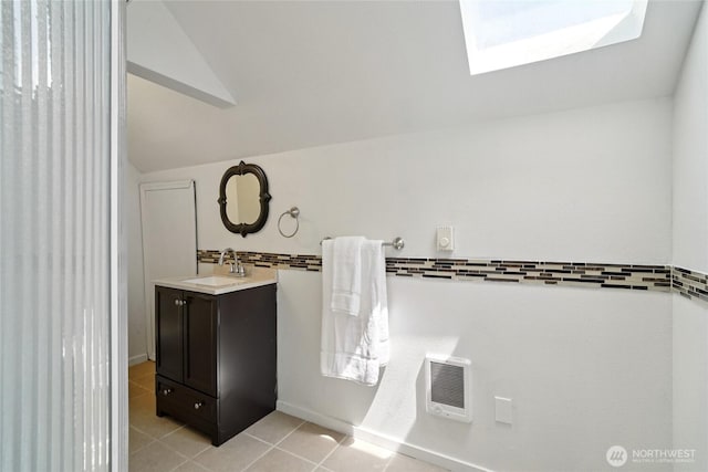6817 S D St, Tacoma, WA 98408 - bathroom featuring vanity, a skylight, lofted ceiling, tile patterned flooring, and heating unit