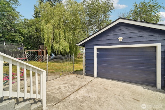 6817 S D St, Tacoma, WA 98408 - detached garage with concrete driveway and a trampoline