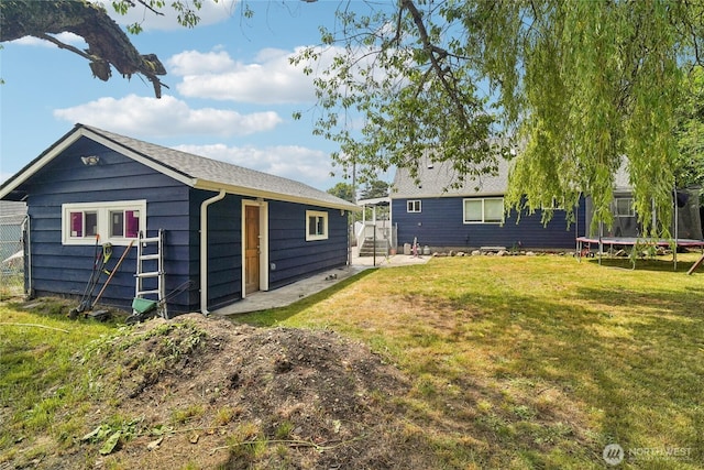 6817 S D St, Tacoma, WA 98408 - back of house featuring a trampoline and a yard