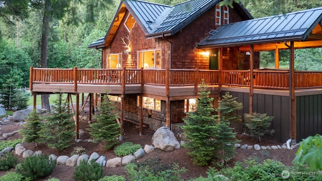 7905 Mountain Home Rd, Leavenworth, WA 98826 - rear view of property featuring a standing seam roof, a metal roof, a deck, and a forest view