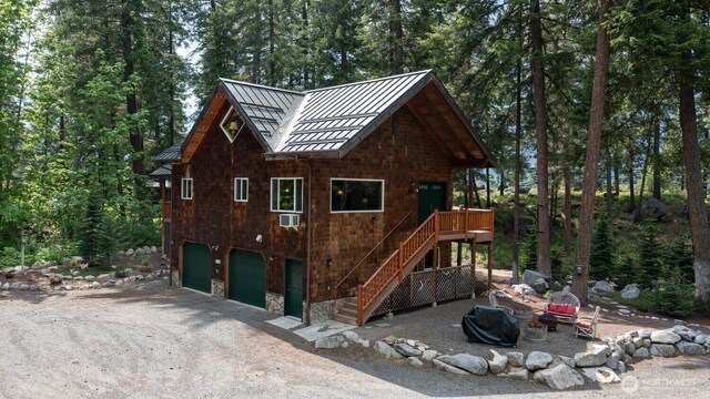 7905 Mountain Home Rd, Leavenworth, WA 98826 - view of side of property with a standing seam roof, a fire pit, a metal roof, driveway, and stairs