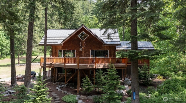 7905 Mountain Home Rd, Leavenworth, WA 98826 - back of property with a standing seam roof, a wooden deck, and a metal roof