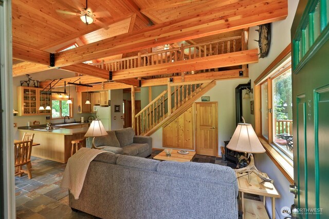 7905 Mountain Home Rd, Leavenworth, WA 98826 - living room featuring stairs, stone finish flooring, and a wood ceiling with exposed beams