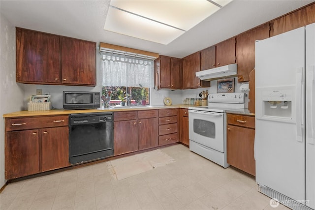 7416 E Heather Way, Everett, WA 98203 - kitchen featuring white appliances, under cabinet range hood, light countertops, and light floors