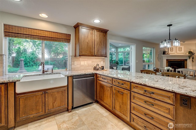 1732 NW 29th Cir, Camas, WA 98607 - kitchen featuring dishwasher, a peninsula, brown cabinetry, decorative backsplash, and recessed lighting