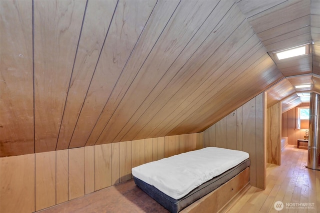 12319 744th Ave NE, Skykomish, WA 98288 - bedroom with vaulted ceiling, wood walls, wooden ceiling, and wood-type flooring