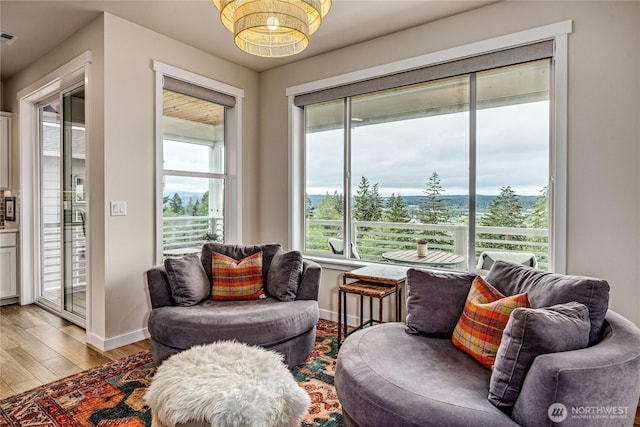 1995 NW Rustling Fir Ln, Silverdale, WA 98383 - living area featuring light wood finished floors and a chandelier