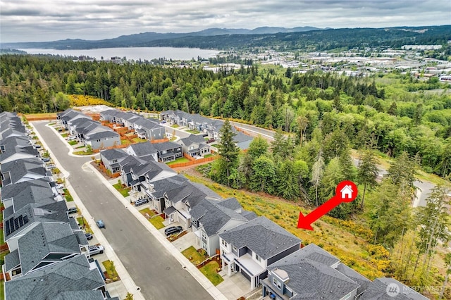 1995 NW Rustling Fir Ln, Silverdale, WA 98383 - aerial perspective of suburban area with a water and mountain view and a heavily wooded area