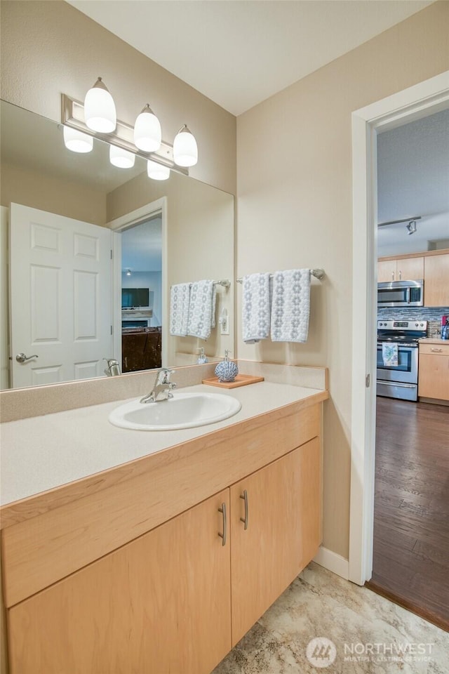 262 Oyhut Bay Blvd SW Unit 204, Ocean Shores, WA 98569 - bathroom featuring vanity and decorative backsplash