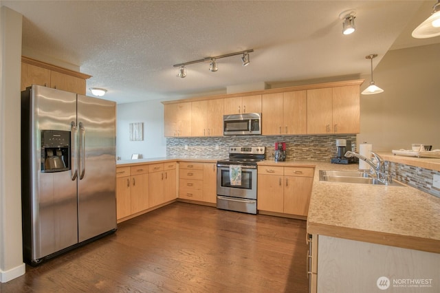 262 Oyhut Bay Blvd SW Unit 204, Ocean Shores, WA 98569 - kitchen featuring appliances with stainless steel finishes, light brown cabinetry, a peninsula, light countertops, and tasteful backsplash