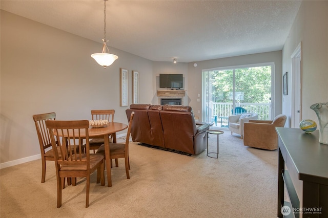 262 Oyhut Bay Blvd SW Unit 204, Ocean Shores, WA 98569 - dining space featuring light carpet and a glass covered fireplace