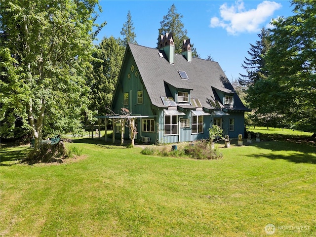 5513 Homestead Ln, Anacortes, WA 98221 - back of house featuring a lawn and a chimney