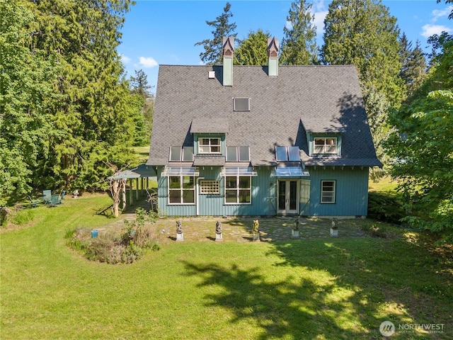 5513 Homestead Ln, Anacortes, WA 98221 - rear view of property featuring french doors, a lawn, a chimney, and a shingled roof