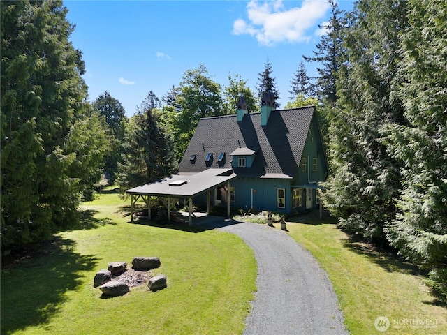 5513 Homestead Ln, Anacortes, WA 98221 - view of front facade featuring a carport, driveway, a front yard, and a chimney
